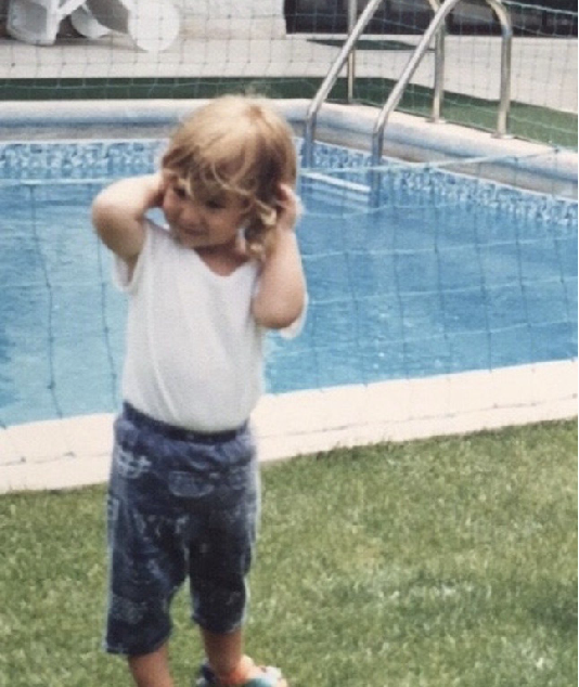 Lara as a child by the pool